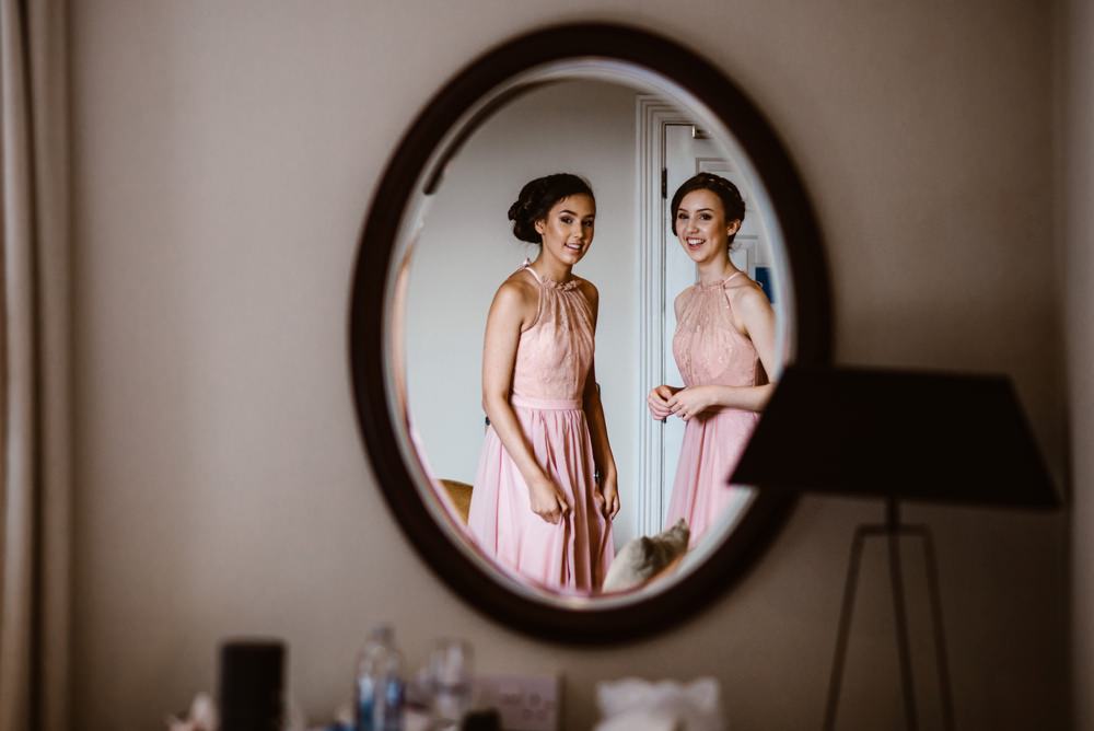 Two bridesmaid reflected in the mirror