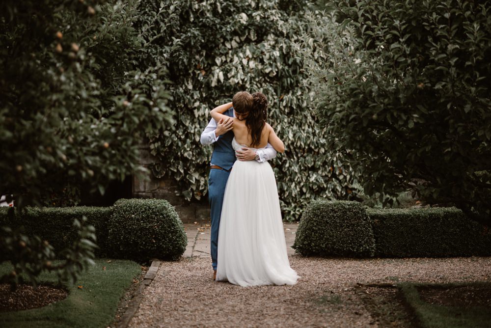 Beautiful shot in the garden with the couple embracing