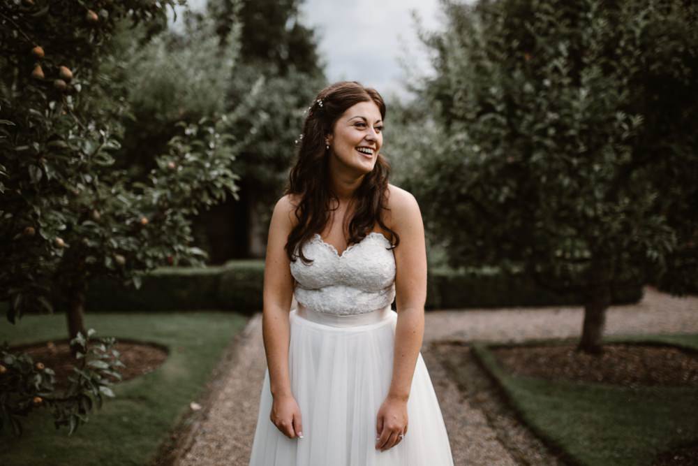 Bride laughing in the gardens