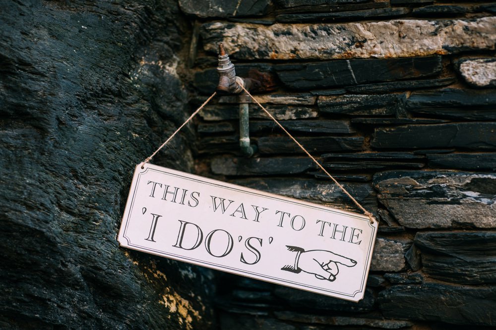 Sign hung on tap on cliff that says 'this was to the I dos"