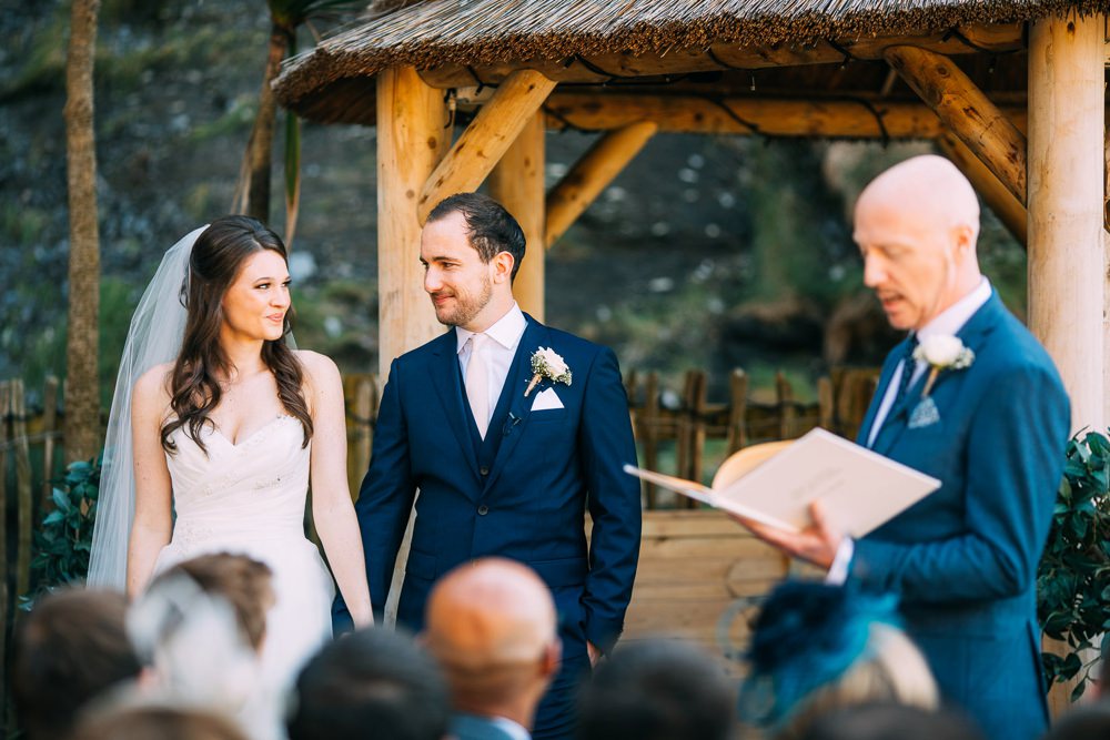 Bride and groom smile at each other during the ceremony
