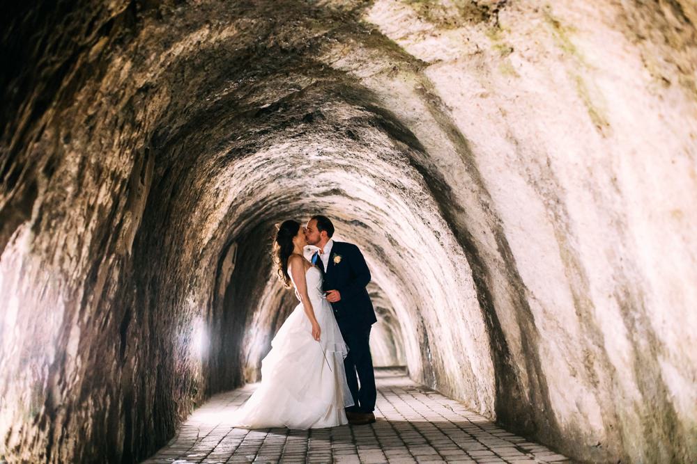 couple kiss in The Tunnels at end of wedding