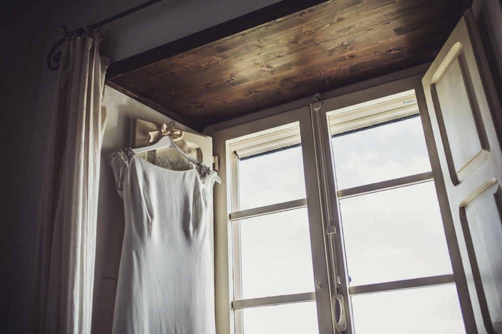 Beautiful Pronovias dress hanging in window frame