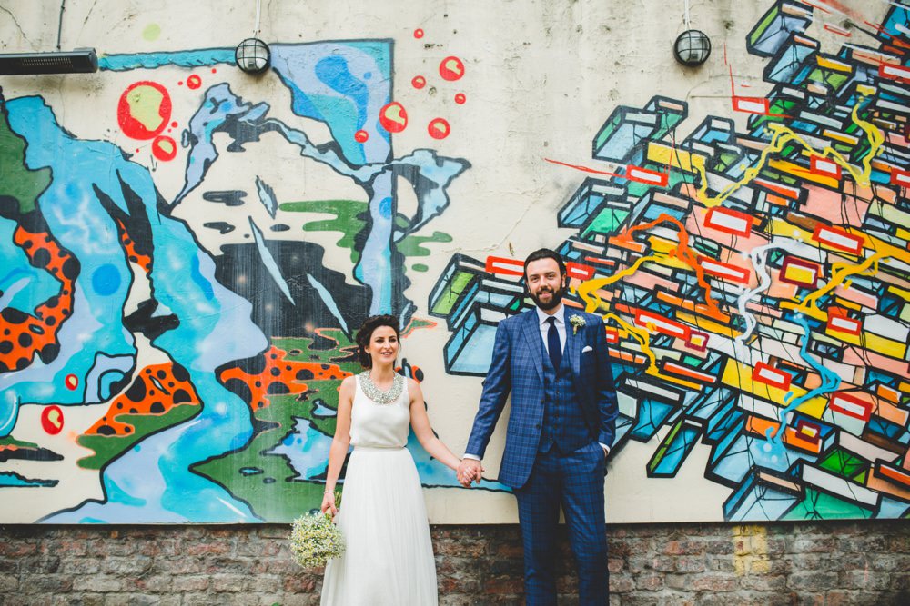 couple against grafitti wall
