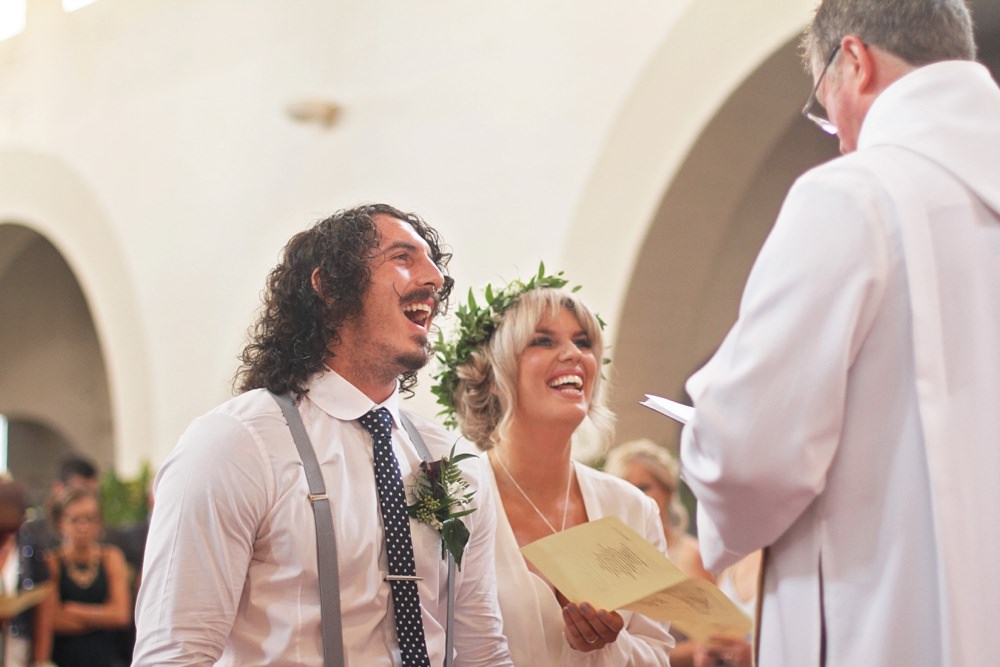 groom and bride laughing during ceremony