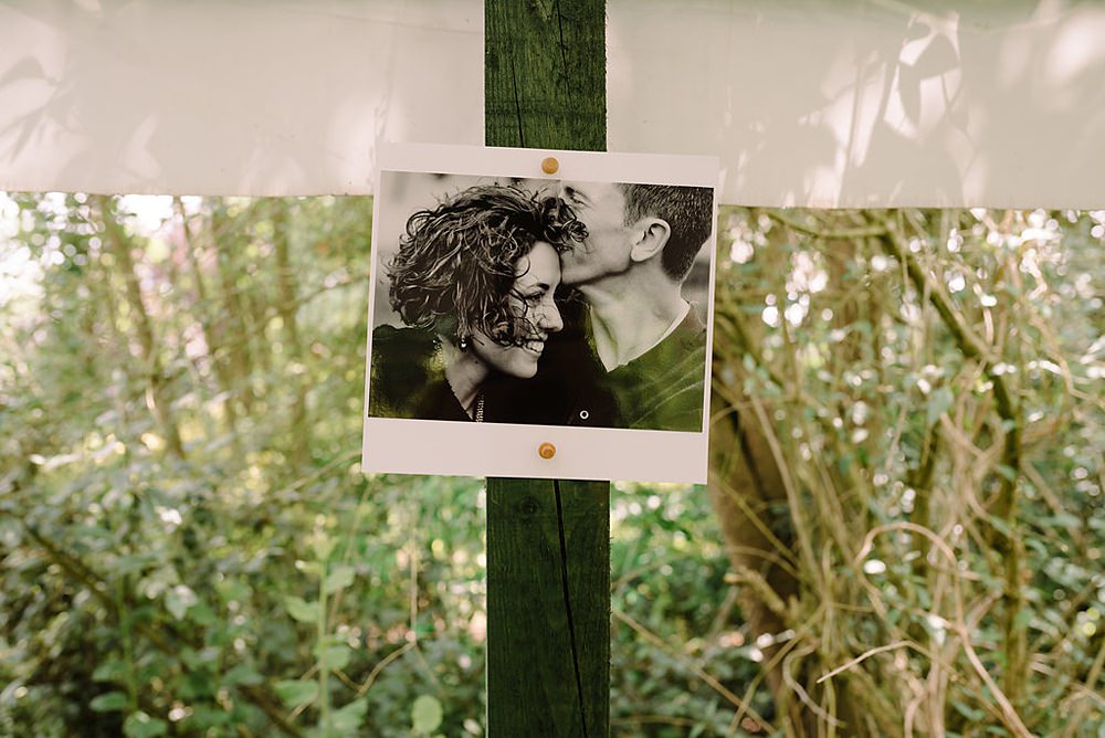 photos of the couple hanging in the marquee